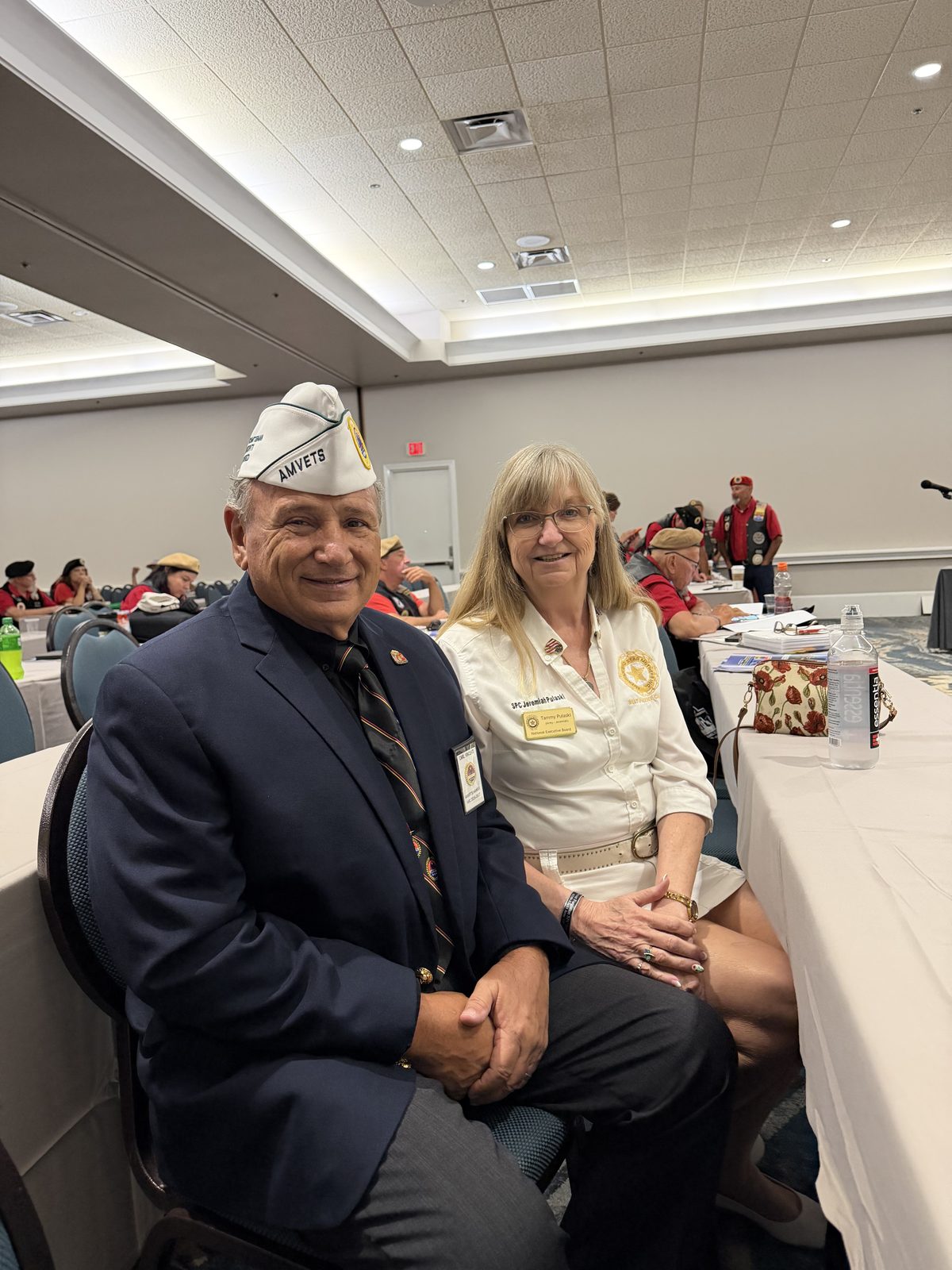 Two AMVETS members seated at a committee table during the convention.
