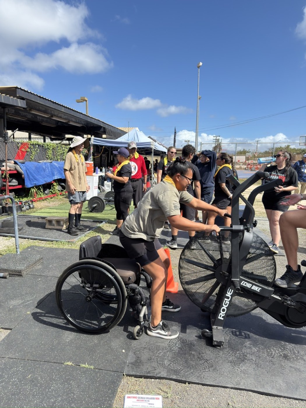 Adaptive athlete transferring from wheelchair to the echo bike at Big Tire Bootcamp