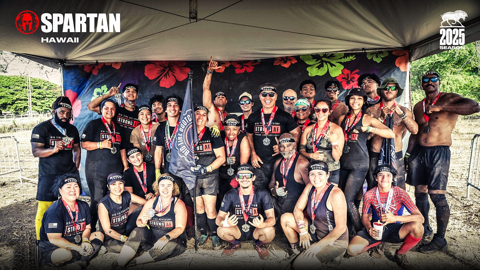 The Big Tire Bootcamp team with medals and the BTB Strong AF flag at Spartan Race Hawaii 2025